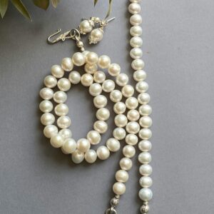 Luxurious pearl necklace and earrings set with elegant silver clasps.